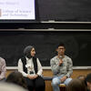 Students talking in front of a room