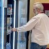 A man selecting a drink from the vending machines in the Ambler Campus Cafe.