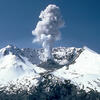 The top of Mount Saint Helens. A crater in the top of a mountain, with a small volcano cone in the middle of it