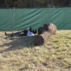Non-Lethal Training Ammunition area, cadet behind a log