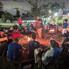 people sitting around a campfire