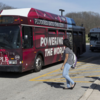 students getting on a bus