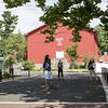 students walking in front of the red barn gym
