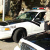 Student cadets next to a law enforcement training car