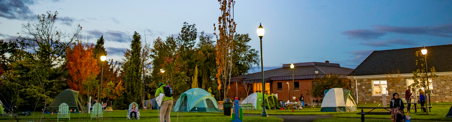 Ambler campus at dusk with tents set up on the lawn