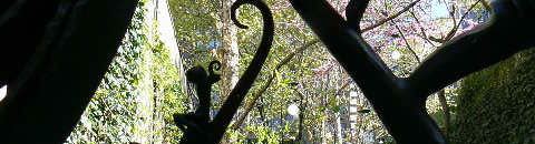 a wrought iron figure in a park designed by John Collins