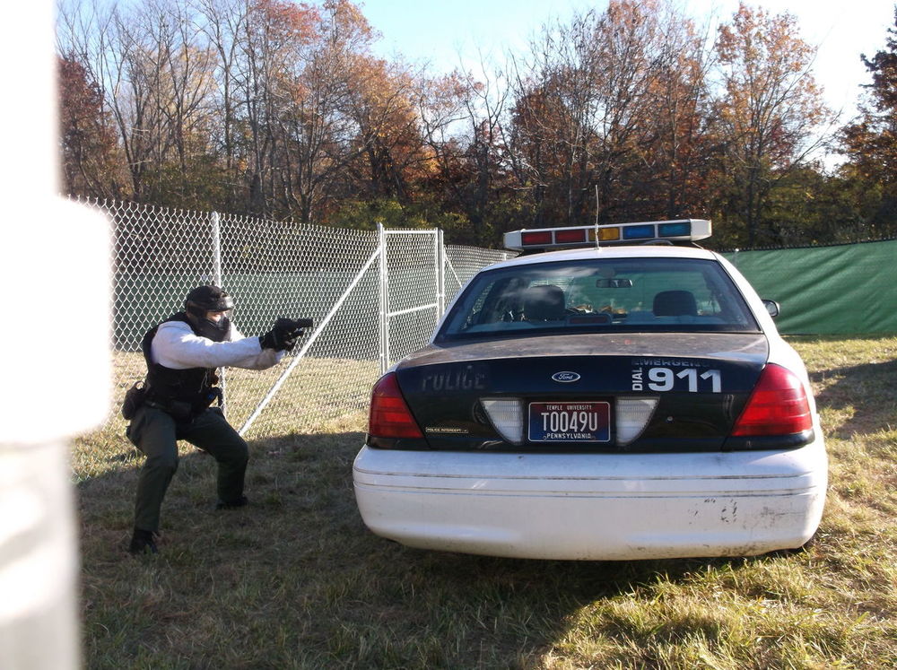 Non-Lethal Training Ammunition area, cadet behind a car