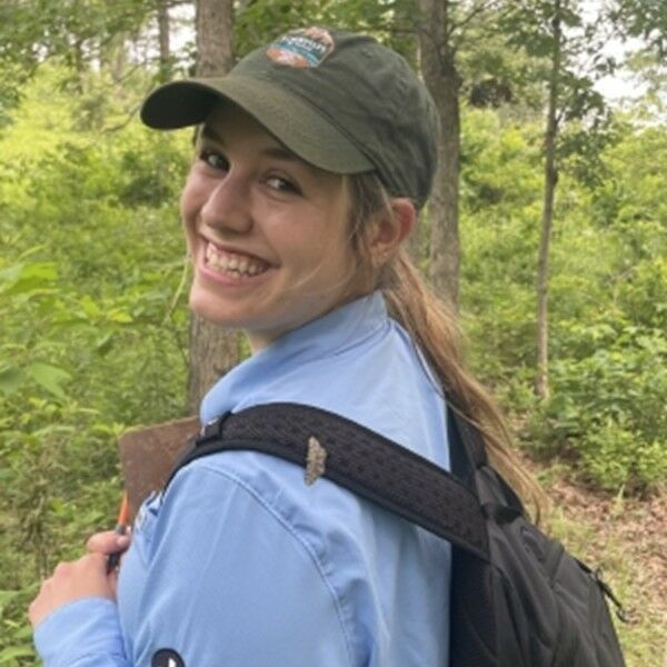 Gabi Cano in the woods with a backpack