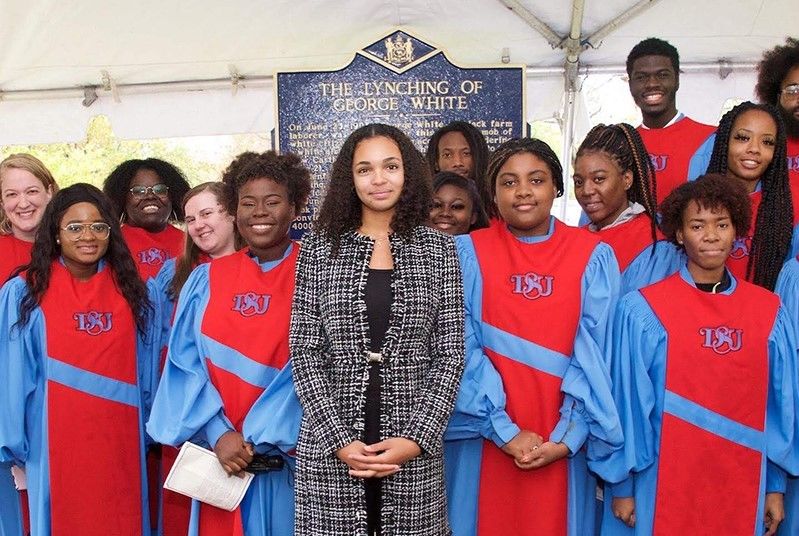 Savannah Shepherd and other people at a dedication ceremony for a plaque 