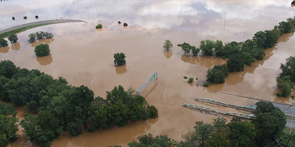 spring flooding, a river flooding its banks everything is covered except for the trees